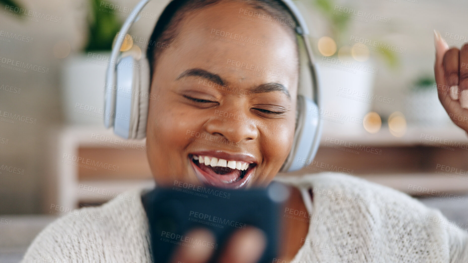 Buy stock photo Black woman, headphones and music with smartphone and happiness, audio streaming and fun while at home. Listening to radio, sound and smile for playlist with energy, dancing and mobile app in lounge