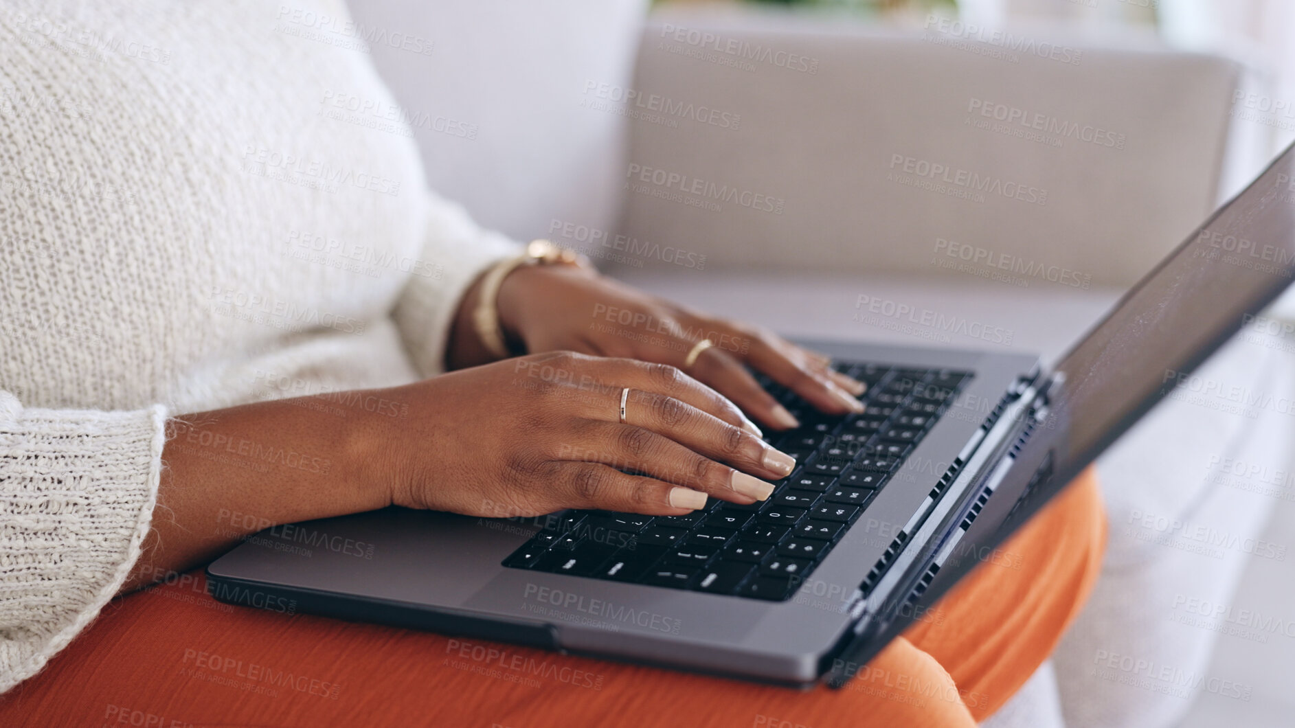 Buy stock photo Hands, laptop and a person typing on a sofa in the living room of her home for email communication. Computer, keyboard and an adult typing a social media post or article for her online blog closeup