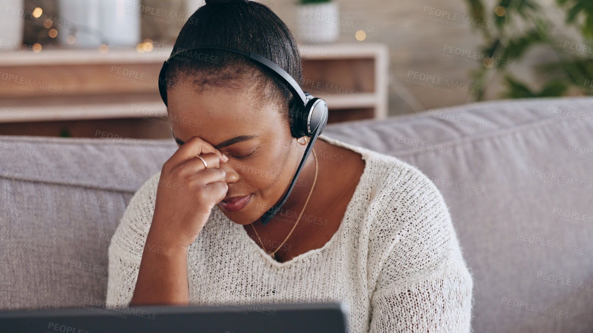 Buy stock photo Stress, customer support and remote work with a black woman consultant on a sofa in the living room of her home. Depression, headache and an unhappy employee problem solving for help or assistance