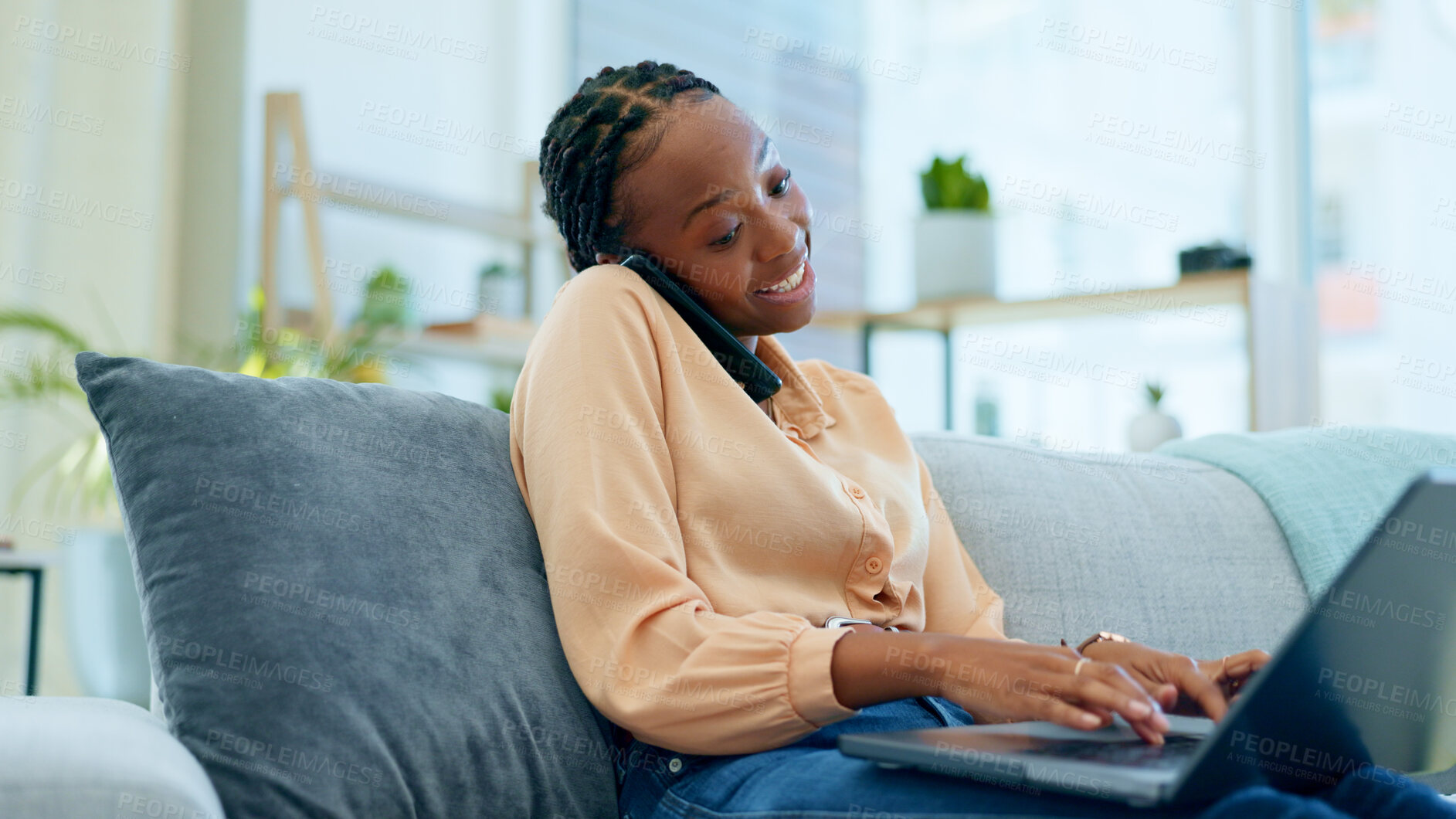 Buy stock photo African woman, phone call and laptop for remote work from home on sofa with smile, typing or decision. Person, click and talk on lounge couch with ideas, solution and smartphone with brainstorming