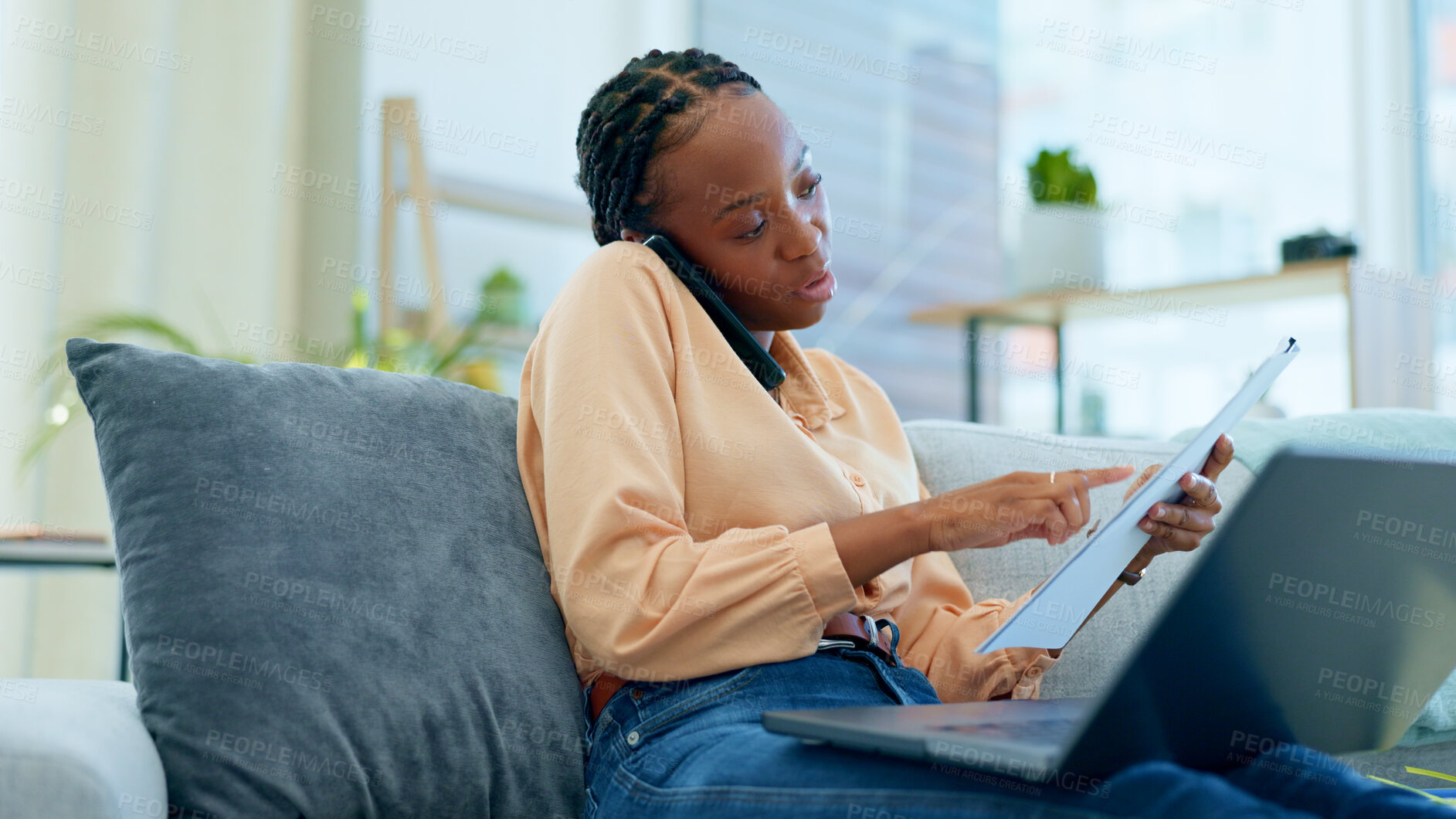 Buy stock photo Woman, phone call and laptop with documents for remote work from home, reading and talk on lounge sofa. African entrepreneur, freelancer person and check paperwork with smartphone, computer and couch
