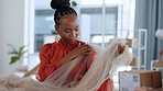 Black woman, designer and fabric for fashion in studio with delivery, logistics or boxes in workplace. Design expert, material inspection and texture check for vision, pattern and clothes in workshop