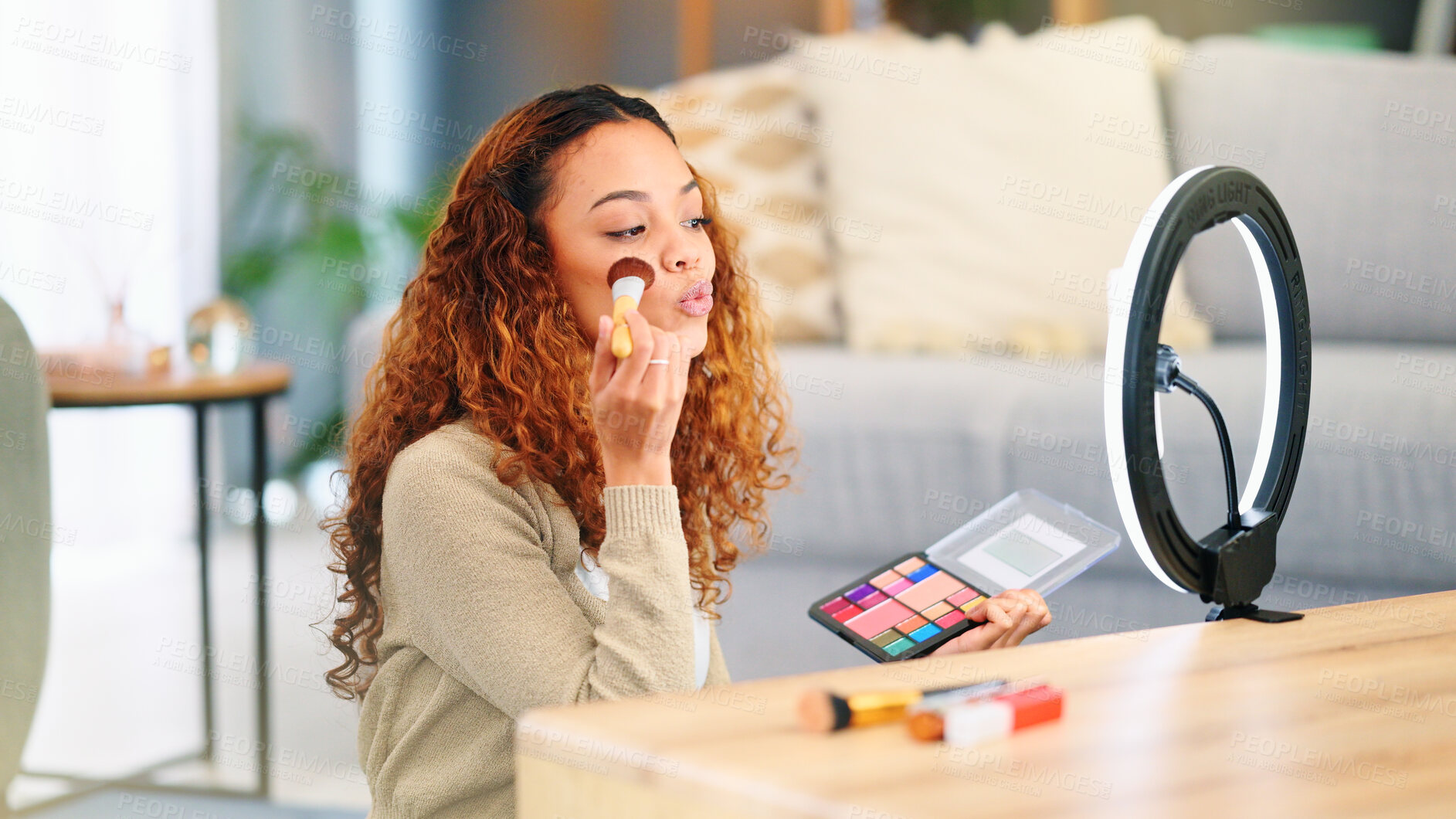 Buy stock photo Influencer woman, makeup and ring light in home with brush, foundation and recording tutorial by table. Girl, cosmetics video and live streaming for beauty, content creation and social media in house