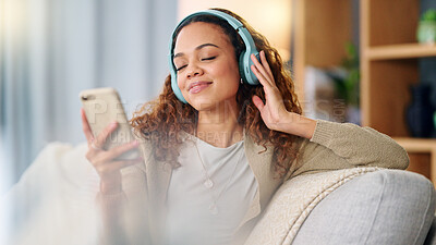 Buy stock photo Woman, headphones and music on couch, phone or thinking with smile, listen and relax in home. Girl, smartphone and happy for audio streaming subscription, app and radio with peace on living room sofa
