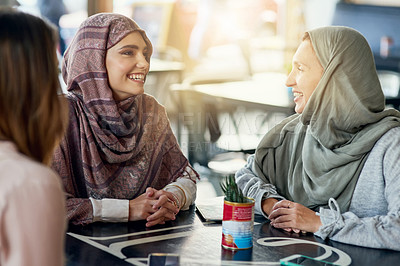 Buy stock photo Friends, funny and Muslim women in cafe, bonding and talking together. Coffee shop, happy and Islamic girls, group or people laughing, conversation and discussion for social gathering in restaurant.