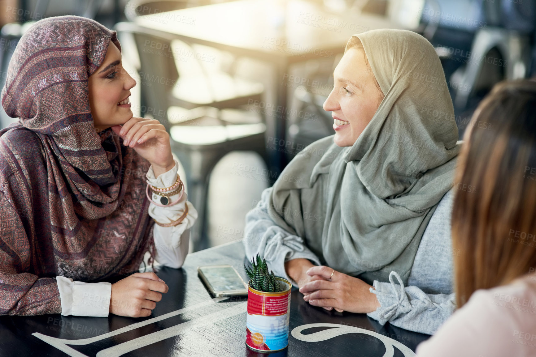 Buy stock photo Smile, friends and Muslim women in coffee shop, bonding and talking together. Cafe, relax and Islamic girls, group or people chat, conversation and discussion for social gathering in restaurant.