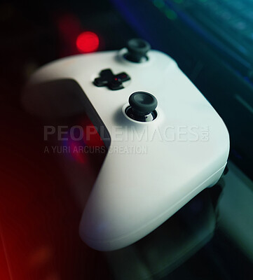 Buy stock photo Closeup of gaming controller, technology to play games and online streaming with esports and video game gadget. Gamer tools, tech on desk and live stream with digital world and streamer joystick