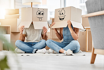 Buy stock photo Funny, couple moving and boxes on head with faces, smile or emoji drawing on cardboard and new house, property or real estate. People, comic and box on body with happiness, crazy or joke in home
