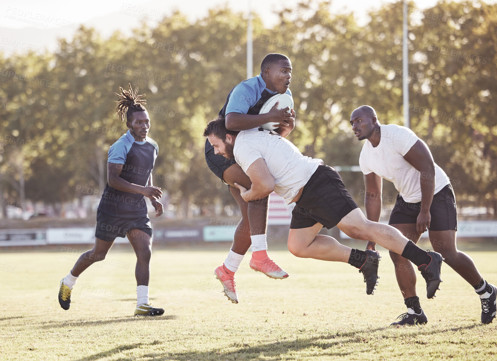 Buy stock photo Sports action, rugby and men on field for match, practice and game in tournament or competition. Fitness, teamwork and players tackle for exercise, training and performance for winning ball to score