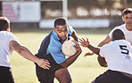 African american rugby player running away from an opponent while attempting to score a try during a rugby match outside on a field. Black man making a play to try and win the game for his team
