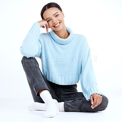 Buy stock photo Portrait, fashion and floor with a woman sitting in studio isolated on a white background looking casual. Smile, contemporary style and clothes with an attractive young female person looking happy