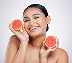 Happy woman, portrait and grapefruit for natural vitamin C, skincare or beauty cosmetics against a white studio background. Female person smile with fruit in healthy nutrition, healthcare or wellness