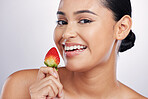 Strawberry, face and beauty portrait woman in studio for skincare glow, dermatology or natural cosmetics. Female person with a fruit in hand for detox, healthy diet and wellness on a white background