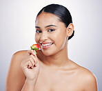 Face, strawberry and beauty portrait of a woman in studio for skincare glow, dermatology or cosmetics. Happy female person with natural fruit for detox, healthy diet or wellness on a white background