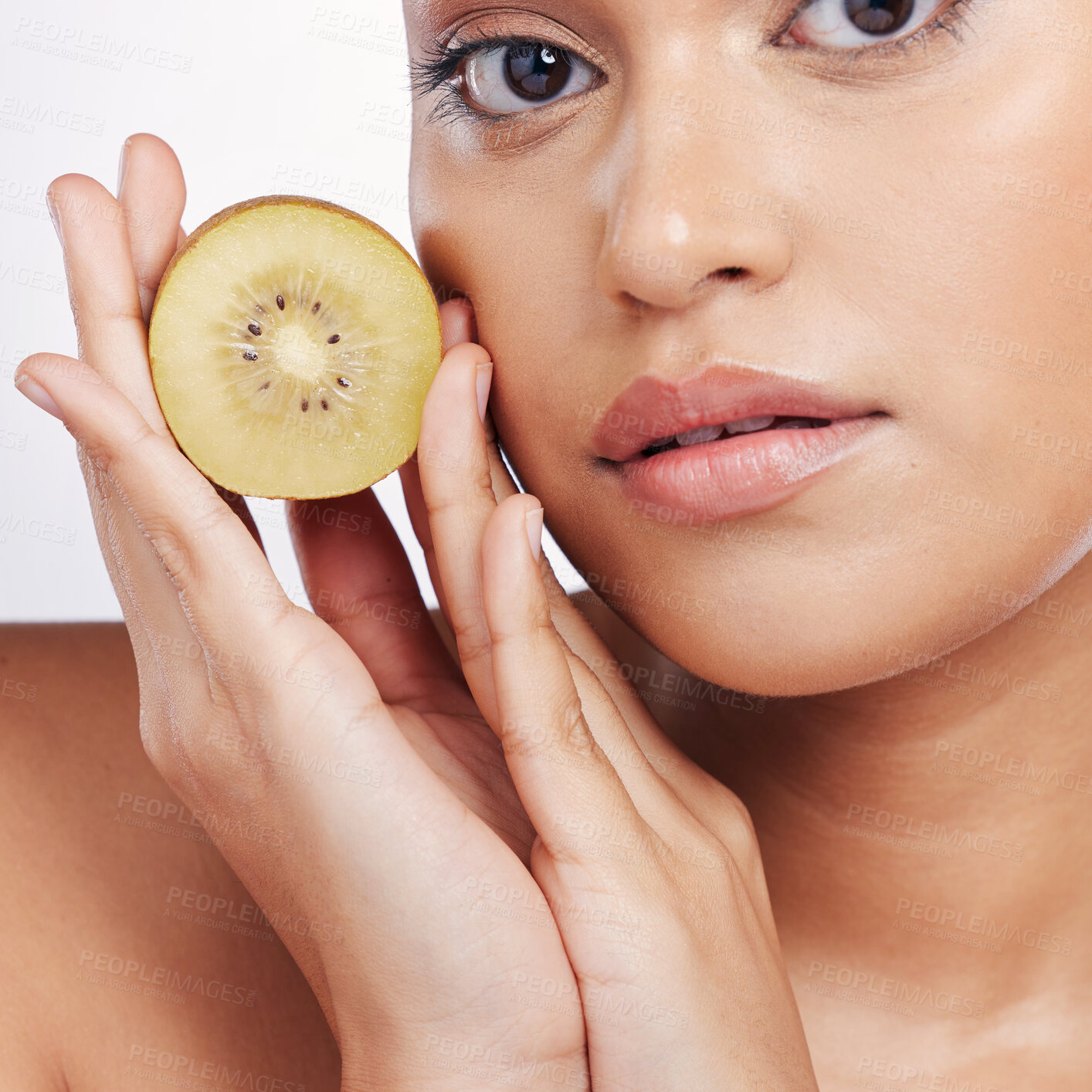 Buy stock photo Woman, portrait and kiwi for natural skincare, vitamin C or beauty cosmetics against a white studio background. Closeup face of female person holding organic fruit for healthy nutrition or wellness