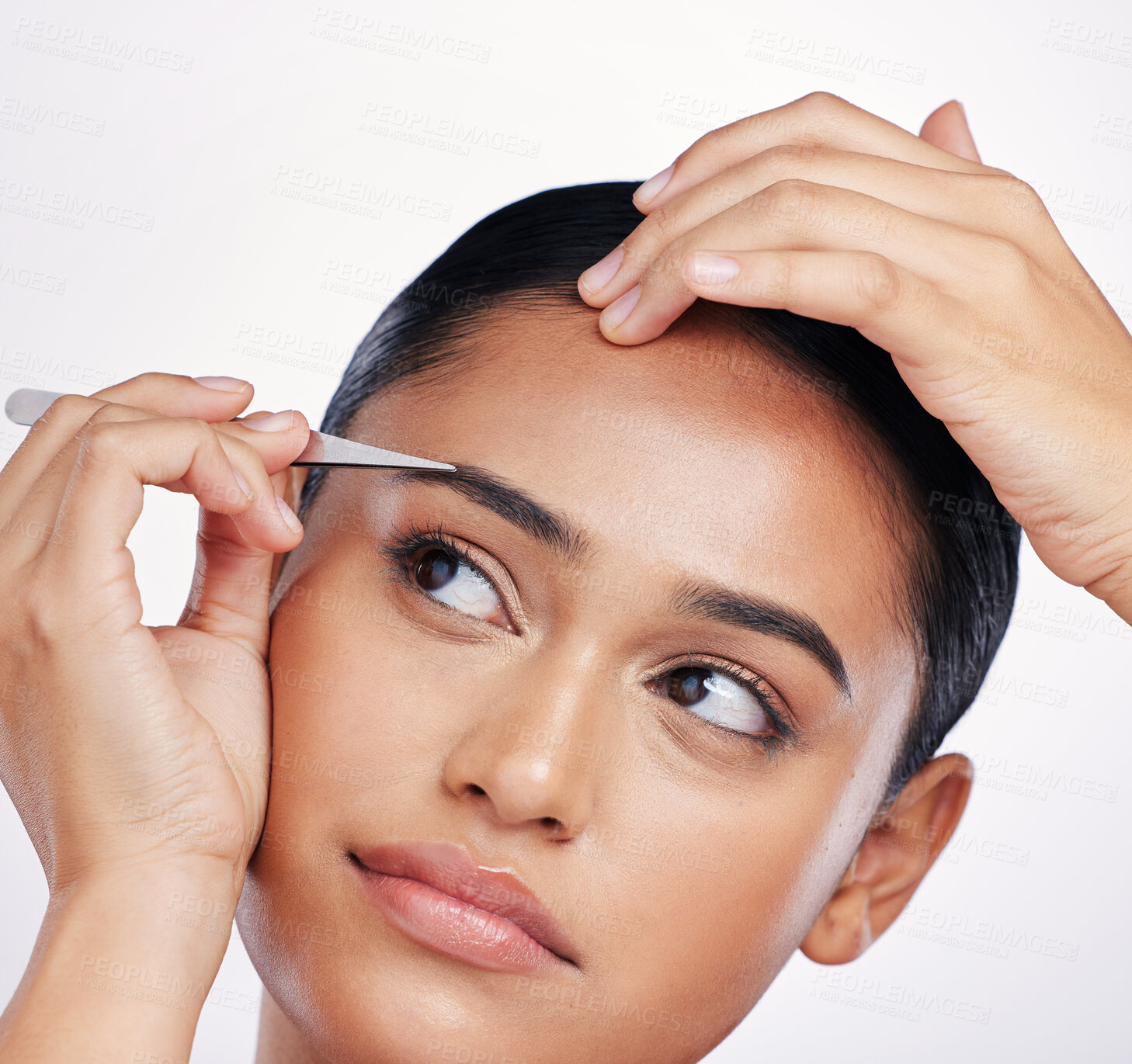 Buy stock photo Face, woman and plucking eyebrows with tweezers in studio for self care and hair removal. Headshot of natural model person with beauty tools in hand for cleaning and grooming on a white background