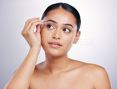 Buy stock photo Face, woman with tweezers and makeup against a studio background. Cosmetics or dermatology, skincare or beauty treatment  and female person shaping her eyebrows for facial care against backdrop