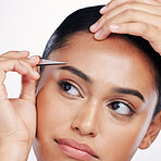 Face, tweezers and a woman plucking eyebrows in studio for self care and hair removal. Headshot of natural model person with cosmetic tools in hand for cleaning and grooming on a white background