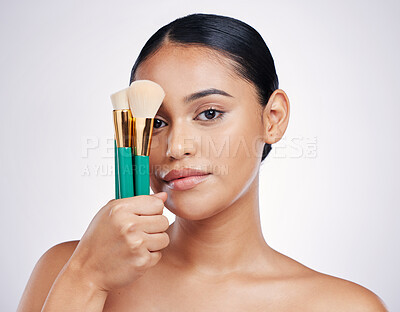 Buy stock photo Makeup brush, face and beauty with woman in portrait, foundation product and powder isolated on studio background. Female model, natural cosmetics and skin glow with cosmetic tools and cosmetology