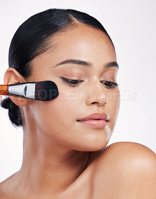 Buy stock photo Beauty, makeup brush and face of a woman in studio for skin glow, cosmetology and cosmetics. Aesthetic female model with cosmetic tools in hand for self care and facial shine on a white background