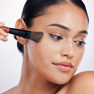 Buy stock photo Makeup, face brush and beauty of a woman in studio for skin glow, foundation or cosmetics. Headshot of a female model with cosmetic tools in hand for facial powder and shine on a white background