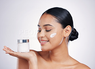 Buy stock photo Happy woman, face cream and product in skincare cosmetics or moisturizer with smile against a white studio background. Female person or model smiling for beauty lotion or facial treatment on mockup