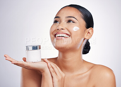 Buy stock photo Happy woman, face and thinking with cream in skincare, moisturizer or cosmetics against a white studio background. Female person model smiling for product, lotion or facial treatment on mockup space