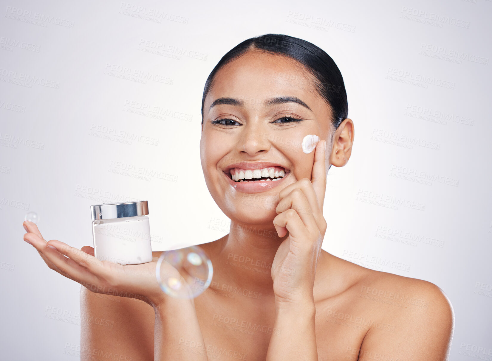 Buy stock photo Happy woman, portrait smile and cream in skincare, moisturizer or cosmetics against a white studio background. Female person or model smiling for product, lotion or facial treatment on mockup space