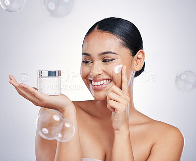 Buy stock photo Skin care, face and beauty cream with a woman in studio for glow, dermatology and cosmetics. Female person with a product container in hand with bubbles, health and wellness on a white background