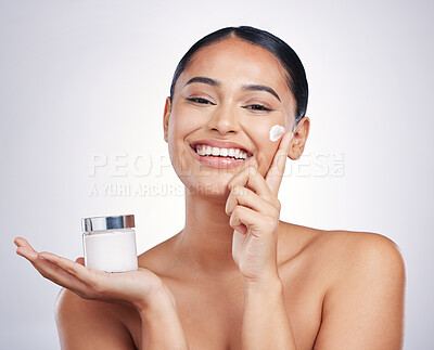 Buy stock photo Happy woman, portrait and cream product in skincare, moisturizer or cosmetics against a white studio background. Female person or model smiling for cosmetic lotion or facial treatment on mockup space