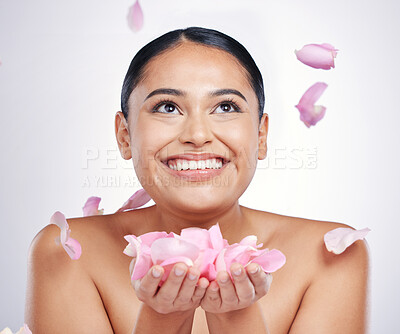 Buy stock photo Flower petals, face and beauty of a woman in studio for skin glow, dermatology and cosmetics. Female person with floral skincare in hand for facial shine, health and wellness on a white background