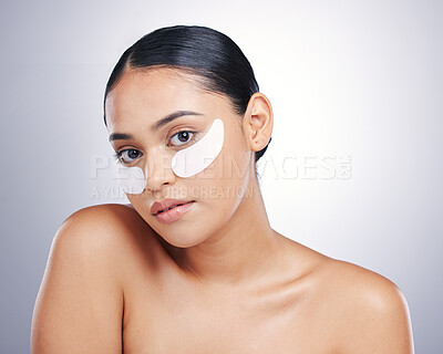 Buy stock photo Face, eye mask and beauty of a woman in studio for glow, dermatology or natural cosmetics. Portrait of model person with collagen skincare patch for facial self care or wellness on a white background