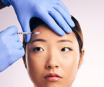 Forehead injection, face skincare and Asian woman in studio isolated on a white background. Cosmetics, syringe and female model with collagen filler, dermatology and prp facelift in plastic surgery.