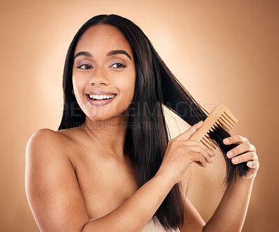 Buy stock photo Smile, woman brush her for hair treatment and against a studio background with a glow. Self care, health wellness and cheerful or excited isolated young female person brushing against backdrop