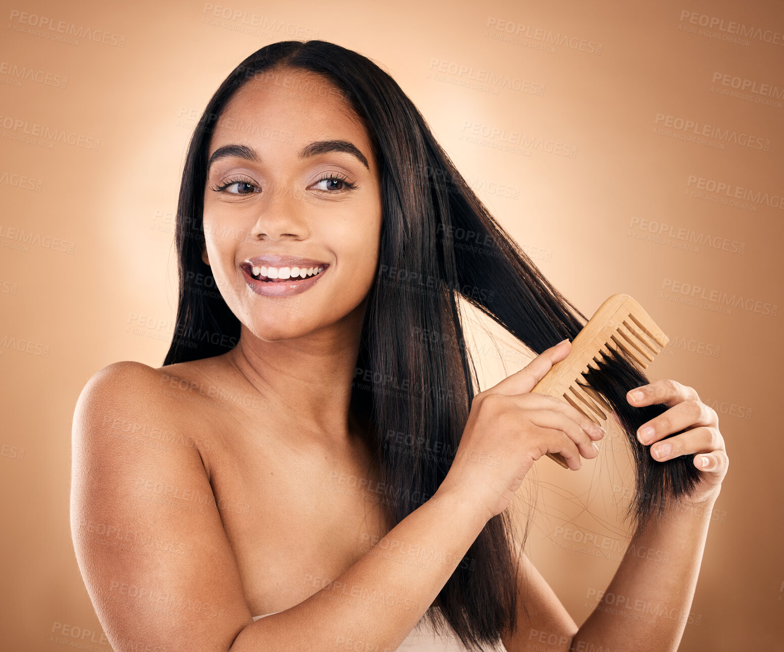 Buy stock photo Smile, woman brush her for hair treatment and against a studio background with a glow. Self care, health wellness and cheerful or excited isolated young female person brushing against backdrop