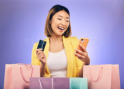 Buy stock photo Japanese woman, credit card and shopping bag in studio with smile for deal, sale or discount with fintech. Gen z asian girl, retail and happy with banking, budget or luxury gift by purple background