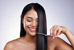 Hair care, smile and woman with scissors on long hairstyle and luxury keratin treatment on white background in Brazil. Beauty, healthy haircut and happy latino model with salon cut on studio backdrop