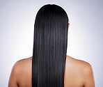 Back, hair care and woman with shine, salon and confident girl against a studio background. Female person, cosmetics or model with treatment, grooming or healthy scalp with luxury, glow and self care