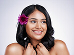 Beauty, smile and face of happy woman with flower in hair, natural makeup and salon treatment on white background. Nature, hairstyle and flowers, face of latino model with haircare on studio backdrop