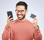 Happy man, smartphone and credit card, online shopping and bonus, discount or promo on studio background. Positive customer experience, ecommerce and fintech, male person excited about sale and win