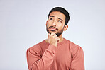 Face, man and thinking of idea in studio or planning, decision and choice with white mockup background. Asian male, model and curious with doubt, questions or thoughtful guy, confused or remember
