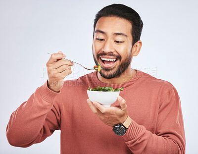 Buy stock photo Man is eating salad, healthy food and nutrition with diet, detox and vegetables isolated on studio background. Health, wellness and vitamins with hungry male person, eat meal and lose weight
