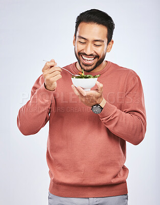 Buy stock photo Man is eating salad, healthy food and lose weight with nutrition, detox and vegetables isolated on studio background. Health, wellness and vitamins with hungry male person, eat meal and diet