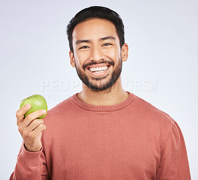 Buy stock photo Man in portrait, apple and nutrition with health and diet with eating isolated on white background. Male person with smile, green fruit and organic with healthy food, detox and lose weight in studio