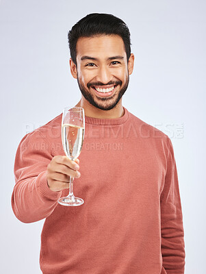 Buy stock photo Man with smile in portrait, champagne and cheers with celebration and happiness isolated on studio background. Toast with alcohol drink in glass, happy male model and party, celebrate with drinking