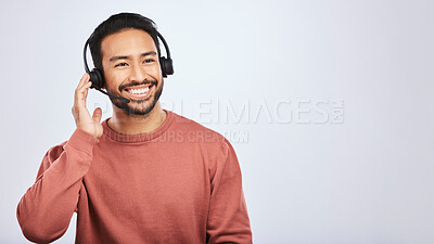 Buy stock photo Man with headset, call center and contact us with smile, mockup space and communication on studio background. Customer service, telemarketing and tech support with male consultant and help desk job