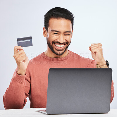 Buy stock photo Excited man, laptop and credit card for online shopping, e commerce and payment in studio. Asian male person with technology and hand to celebrate savings, promotion or sale on a fintech website