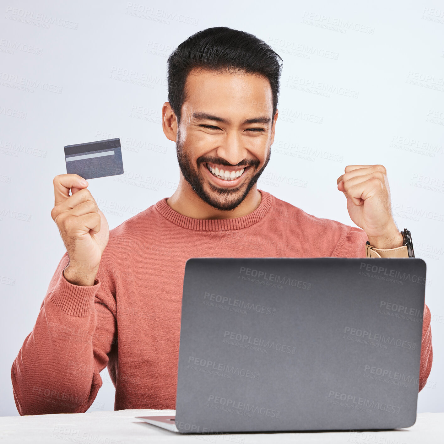 Buy stock photo Excited man, laptop and credit card for online shopping, e commerce and payment in studio. Asian male person with technology and hand to celebrate savings, promotion or sale on a fintech website