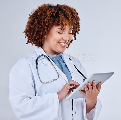 Buy stock photo Tablet, doctor or african woman isolated on a white background for healthcare research, clinic or telehealth services. Nurse or medical person typing on digital tech, paperless or software in studio