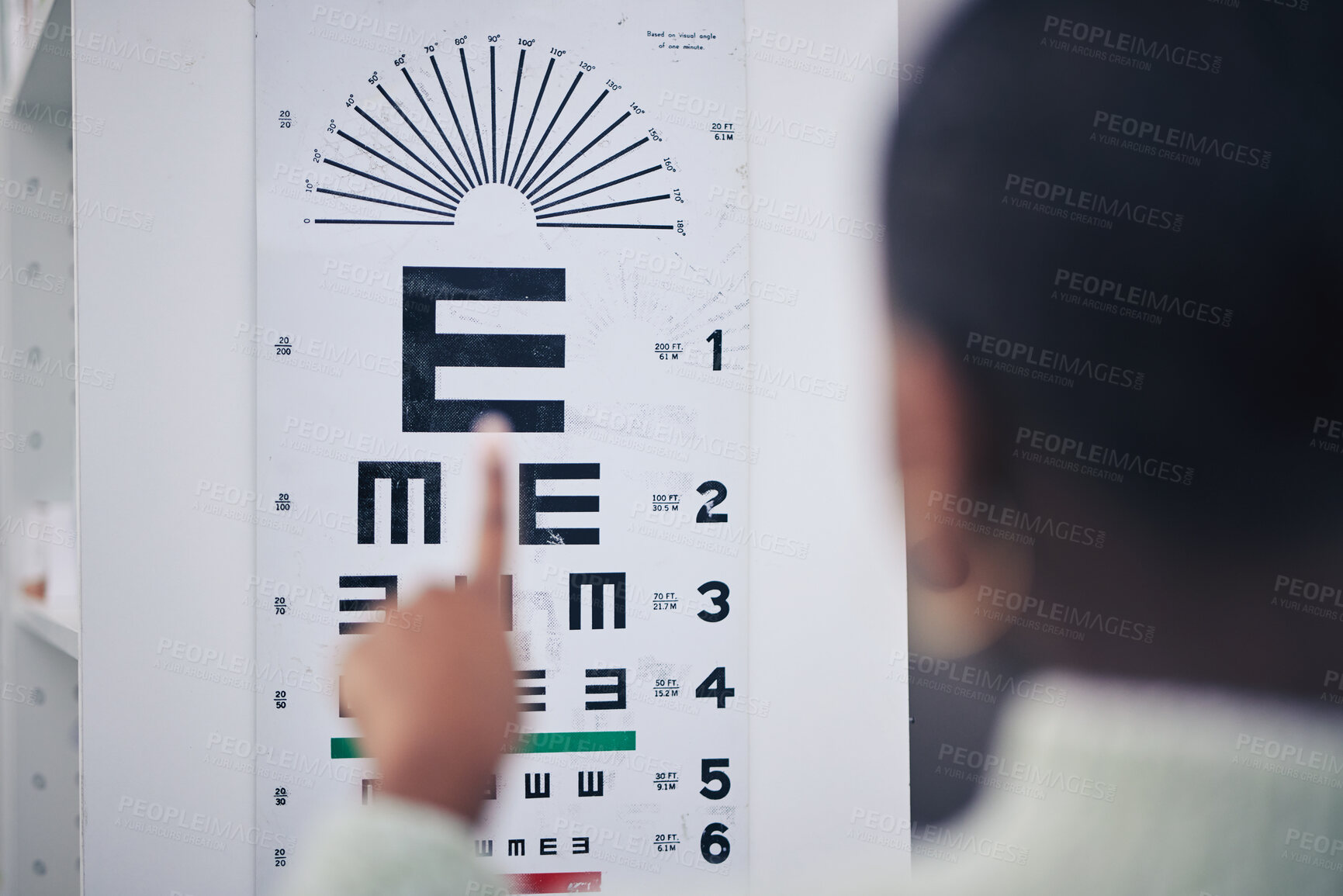 Buy stock photo Eye care, medical and chart for a vision test for prescription lens glasses in an optometry clinic. Ophthalmology, healthcare and back of optometrist doing an optical exam with letter board in store.